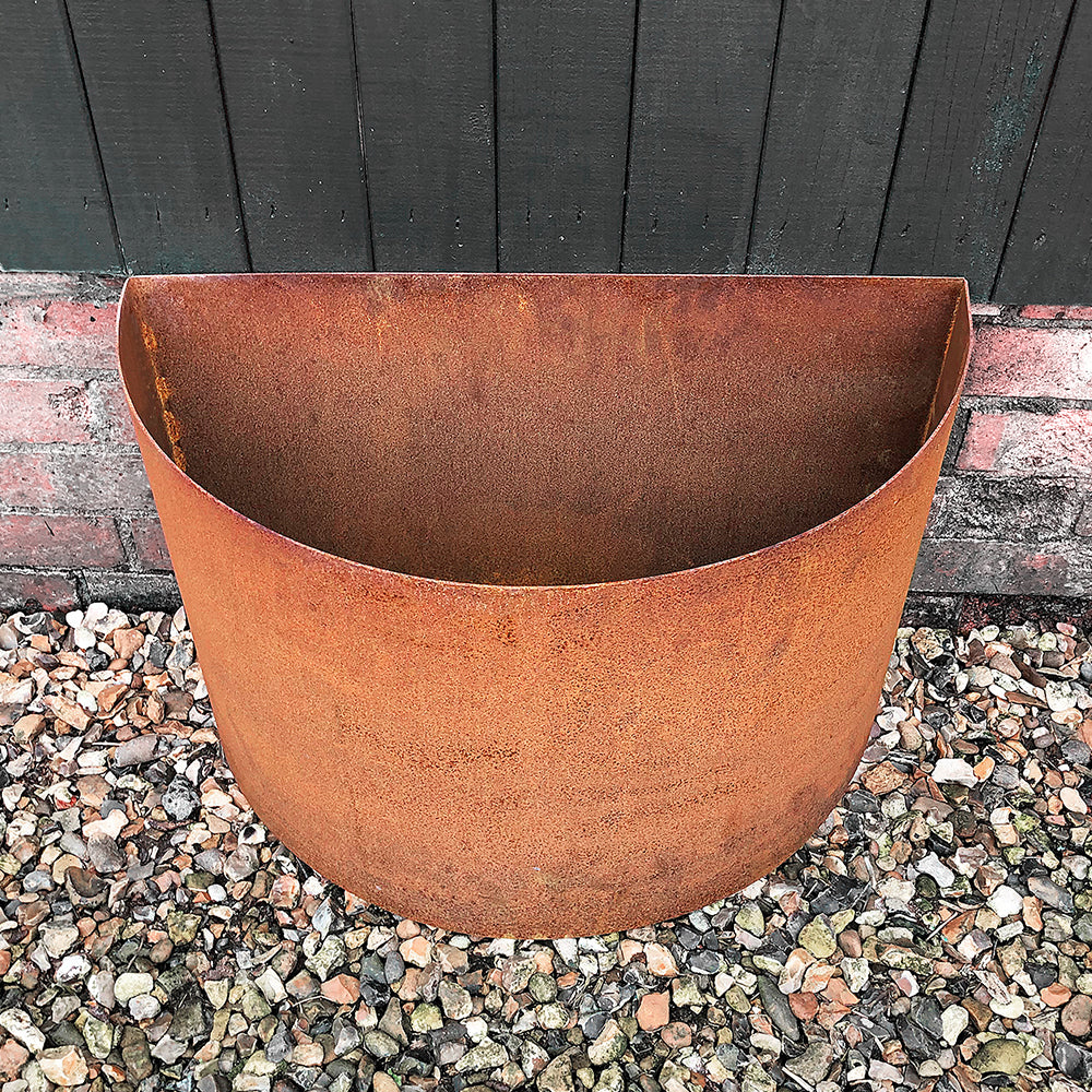 closeup of detailing at top of semi-circle rustic steel planter